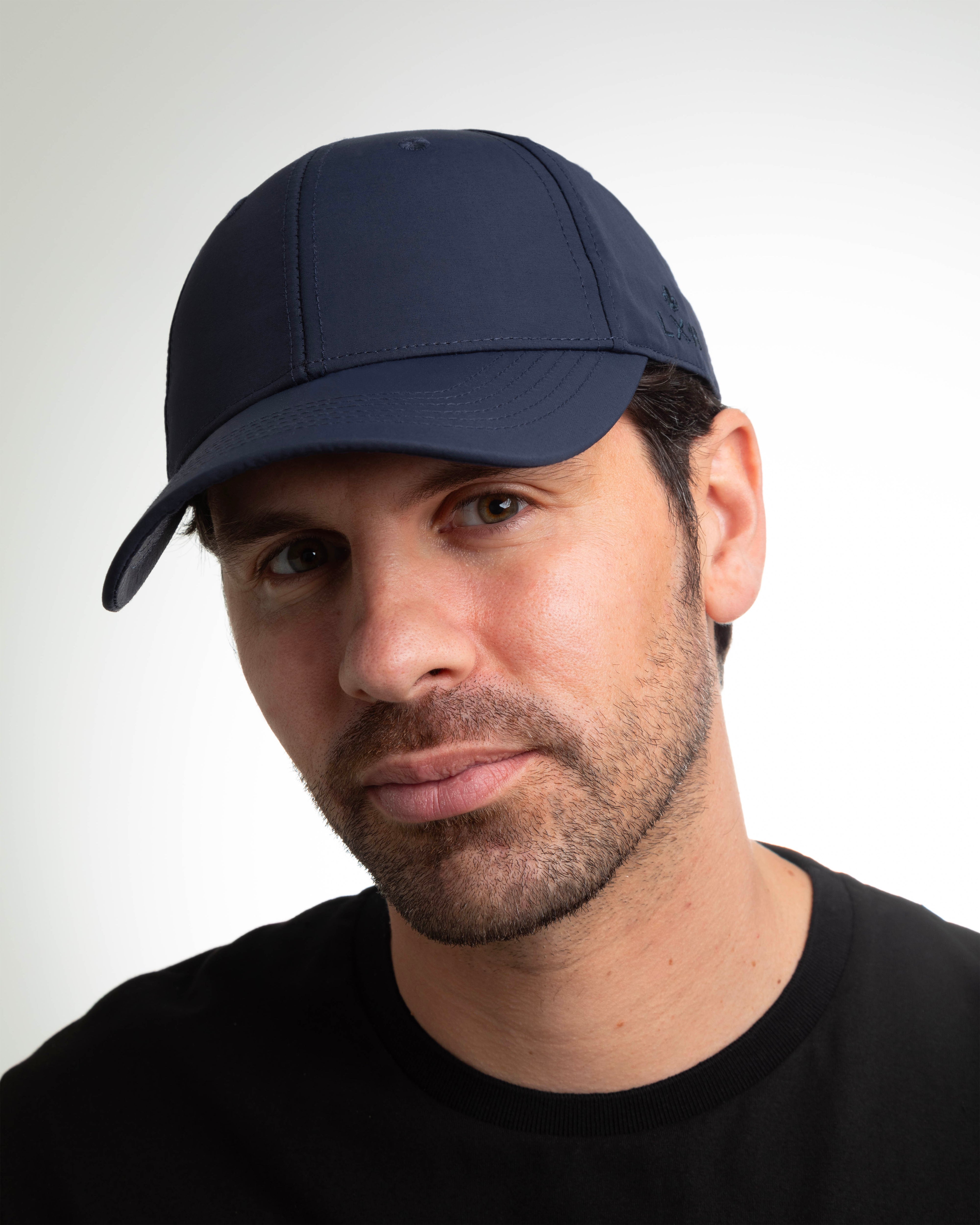 Casquette nylon bleu marine LXH portée par un homme avec une chemise noire