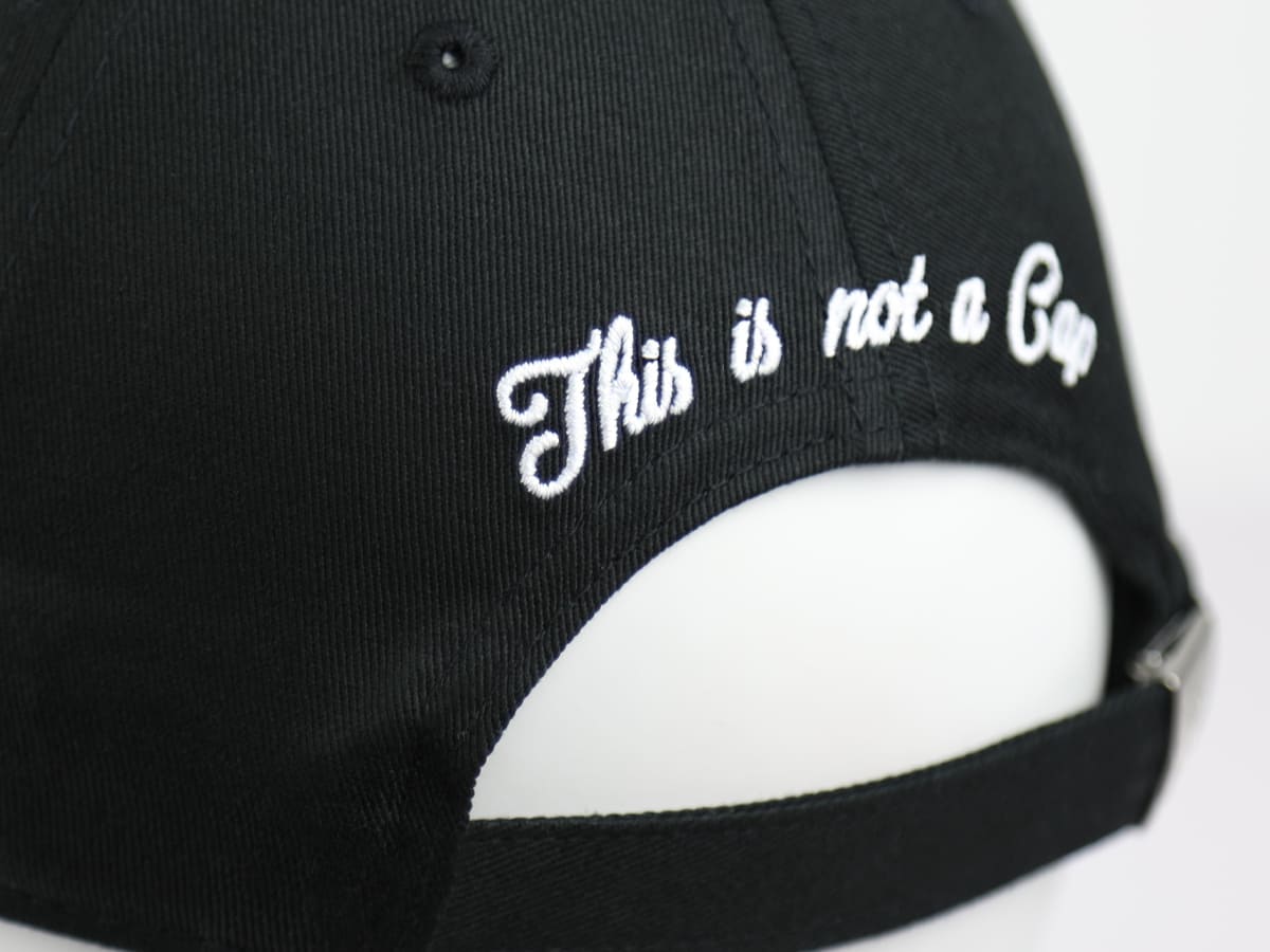Casquette LXH en coton noir avec broderie blanche This is not a Cap et fermeture réglable