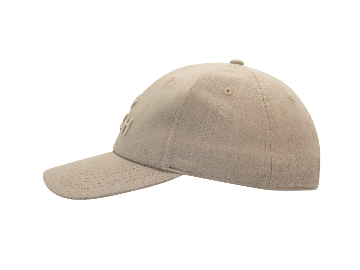 Profil gauche de la casquette Héritage en lin sirocco, trame du lin apparente et visière incurvée.