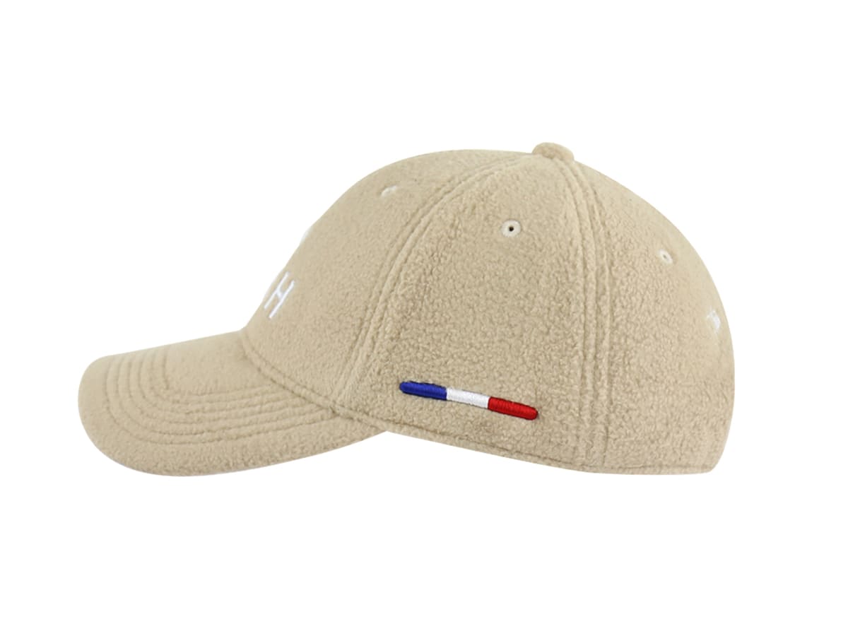 Casquette LXH Héritage polaire beige profil droit, panneaux côtelés et drapeau français brodé sur la couture latérale.