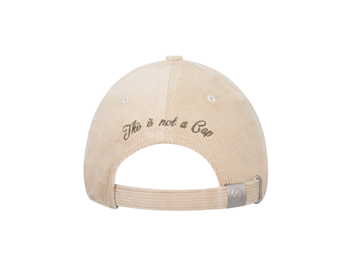 Arrière casquette LXH velours côtelé beige, broderie cursive « This is not a Cap », boucle métal fleur de lys.