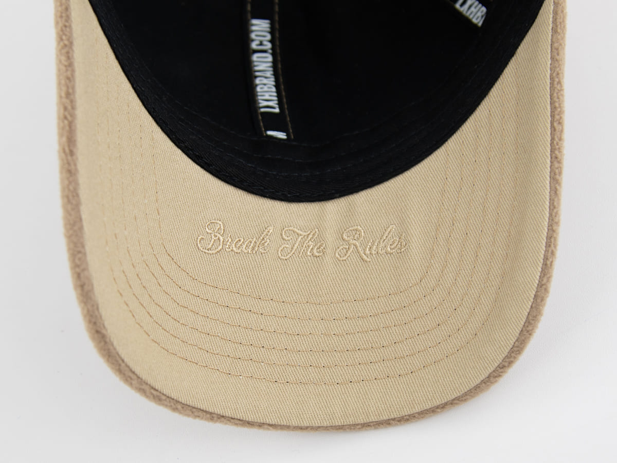 Casquette polaire homme beige avec inscription 'Break The Rules' sur la visière