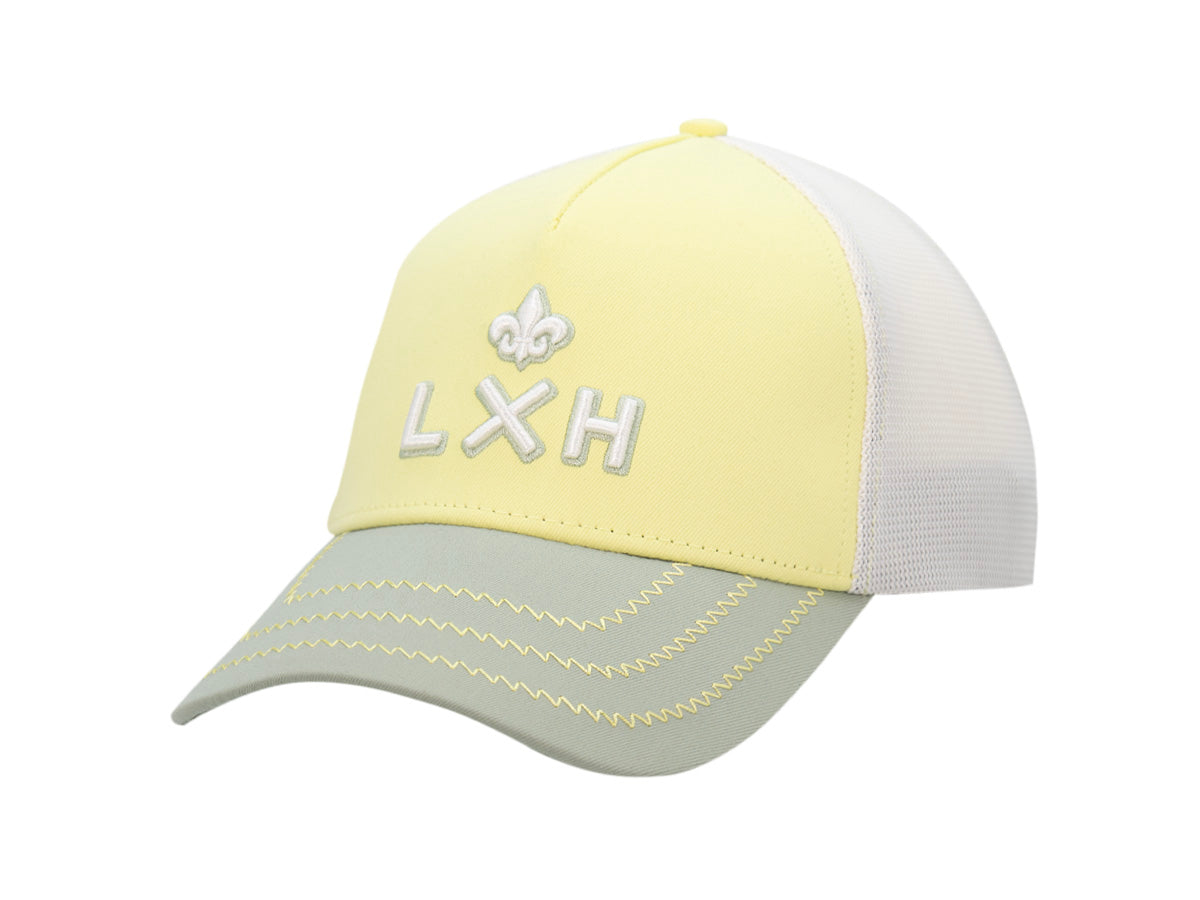 Casquette Évasion LXH citron, façade jaune pâle, mesh blanc et visière vert d'eau, monogramme brodé blanc.
