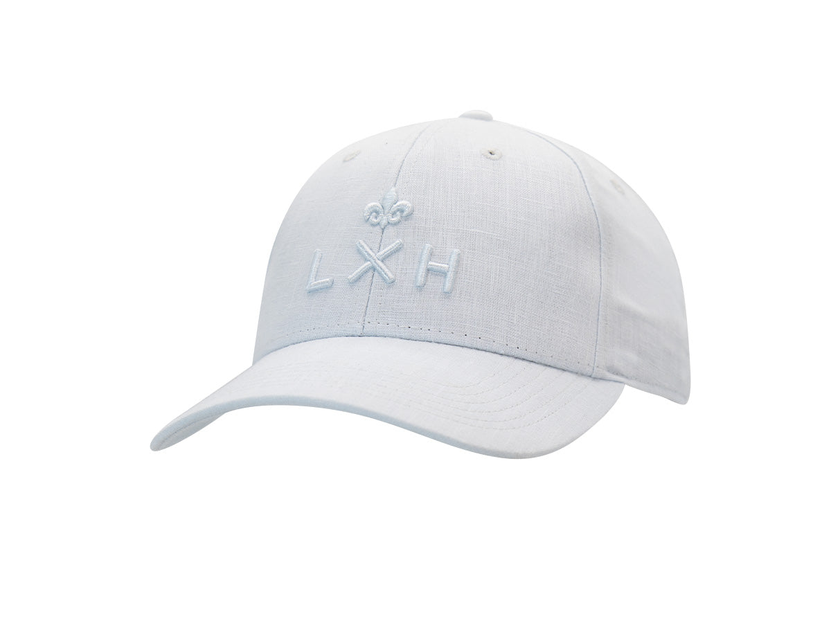 Casquette Héritage LXH en lin bleu glace, trois quarts avant, monogramme LXH et fleur de lys brodés ton sur ton.