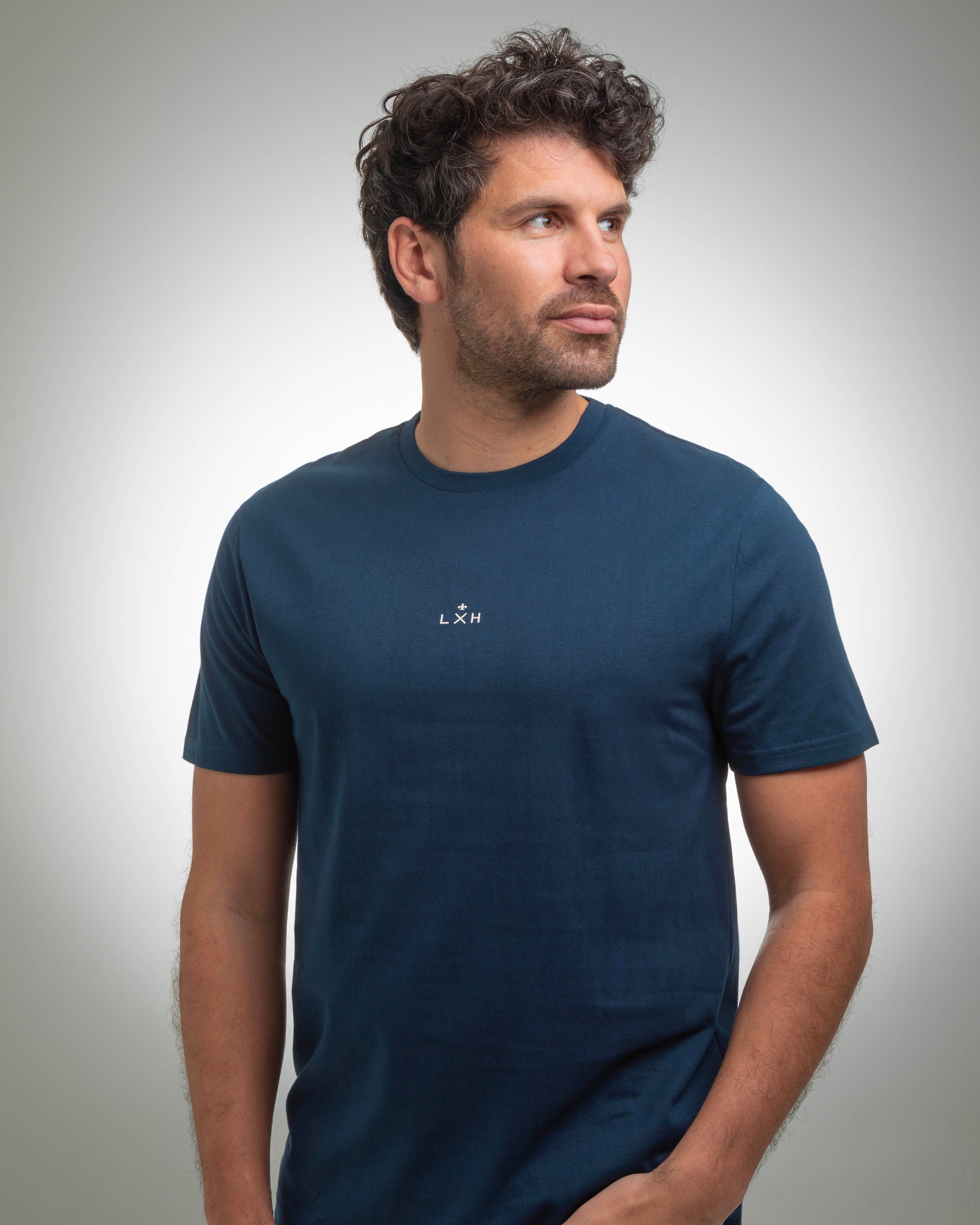 T-shirt Coton LXH bleu marine à manches courtes porté par un homme regardant sur le côté